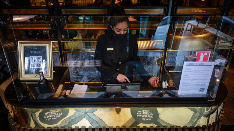 Restaurant reception desk and receptionist