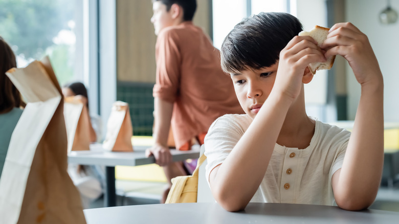 school child sitting in cafeteria 