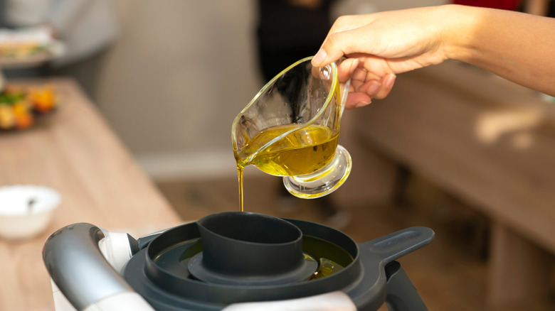 Oil pouring into food processor