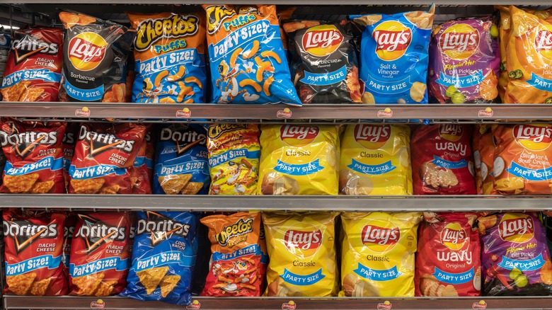 rows of frito-lay chips and snacks on a grocery store shelf