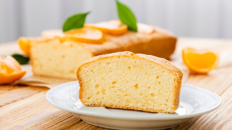 Sliced pound cake with orange wedges