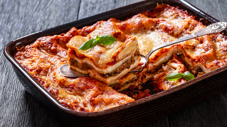 lasagna in tray with slice scooped out