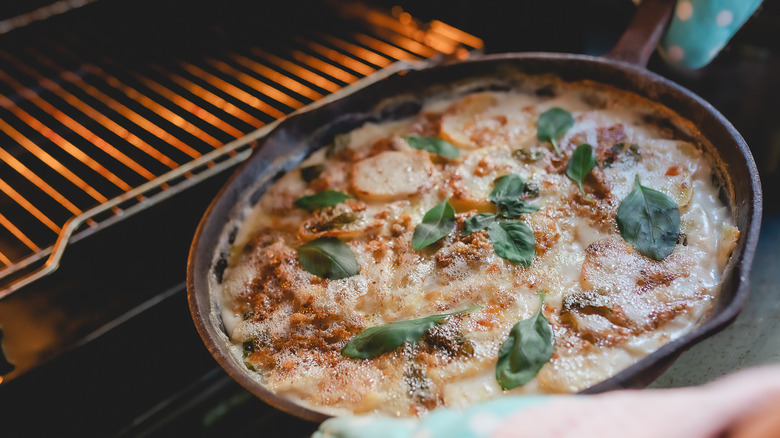 cast-iron dish going into oven