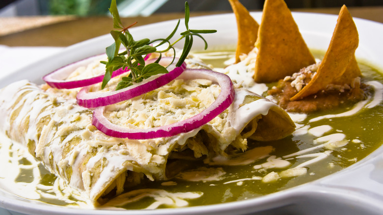 Green enchiladas with red onion on top