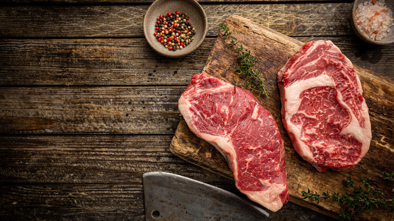 Raw ribeye and New York strip steaks