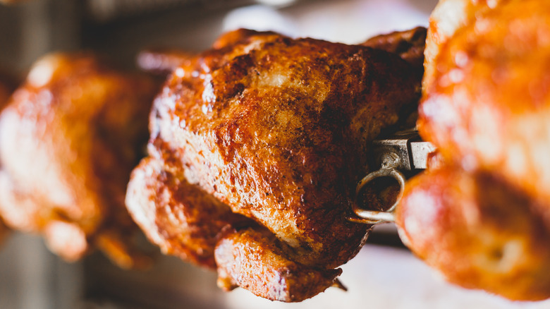 rotisserie chickens rotating in oven