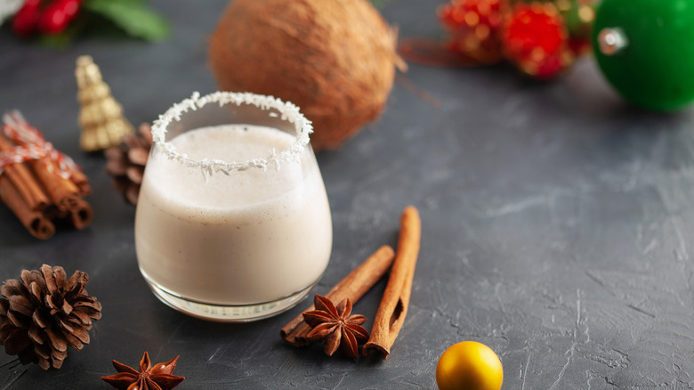 traditional coquito cocktail with sugar rim and whole spices