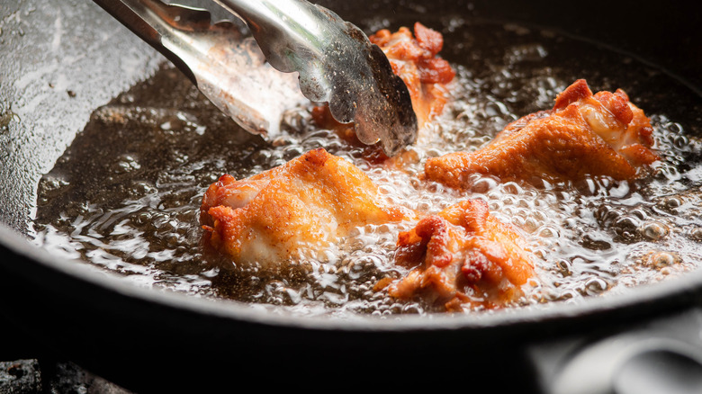 Chicken wings frying in oil 