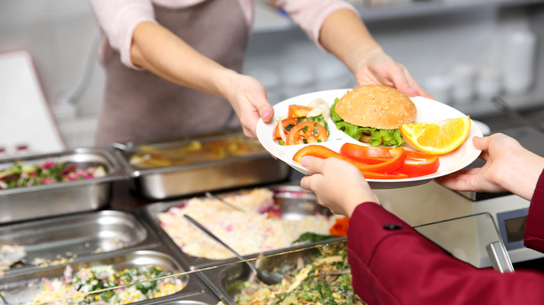 Student accepts lunch in cafeteria 