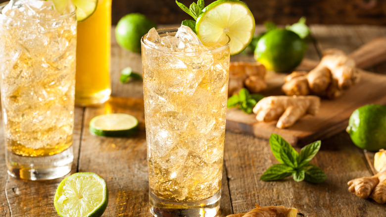 Glasses of ginger beer with ginger, limes