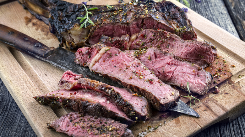 Cut cooked steak on cutting board