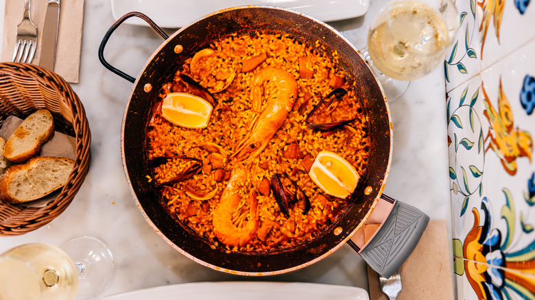 spicy paella and glass of white wine