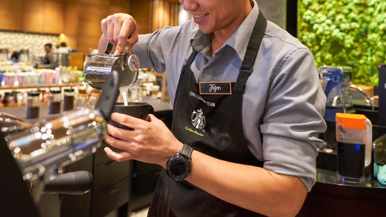 Starbucks employee pouriong drink
