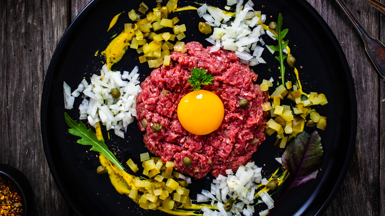 Polish steak tartare on plate with vegetables