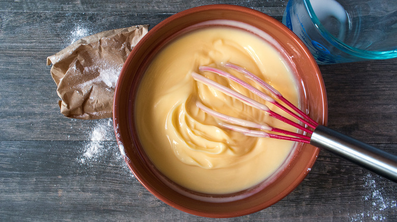 whisk in bowl of pudding