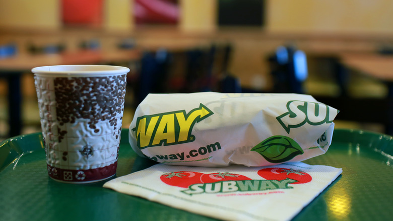 Subway sandwich with paper coffee cup