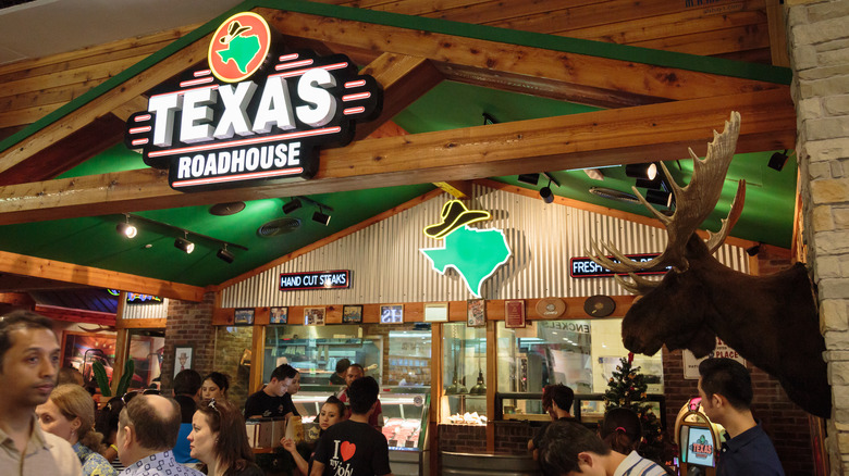 Texas Roadhouse interior with logo and customers