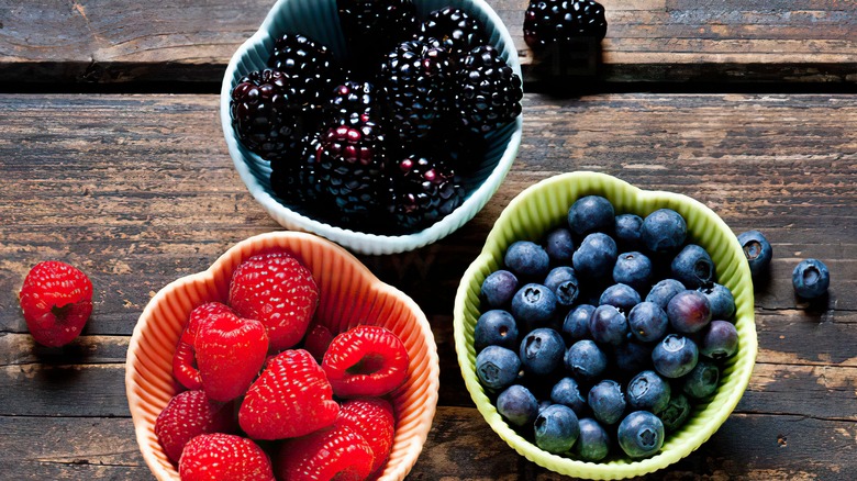 blackberries, blueberries, and raspberries in bowls