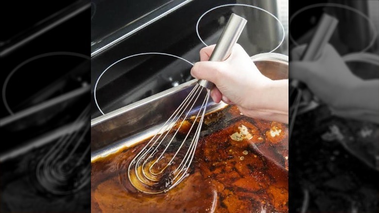 Flat whisk scraping a pan 