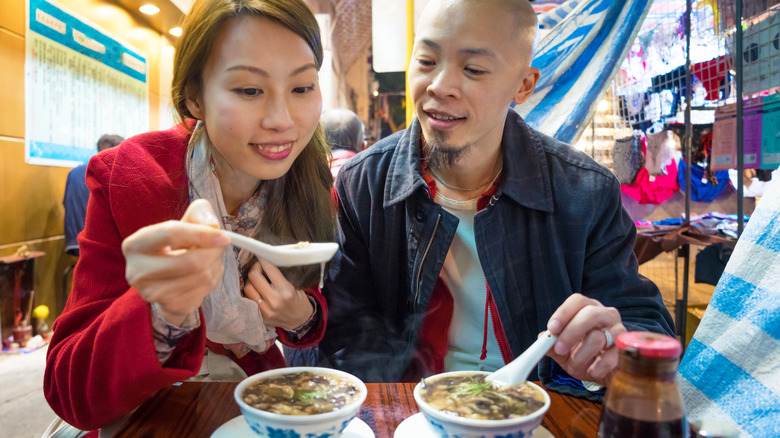 couple eating snake soup