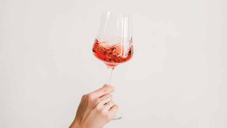 swishing rose in a universal wine glass