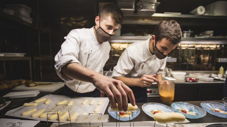 Cooks preparing tasting menu