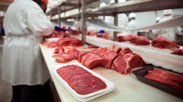 Raw meat being packaged for sale 