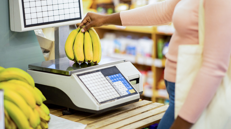 woman weighing bananas on scale