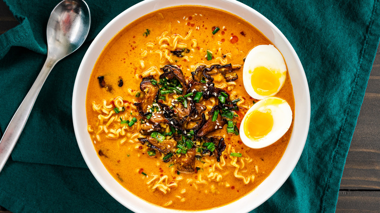 bowl of ramen topped with sesame seeds and sesame oil