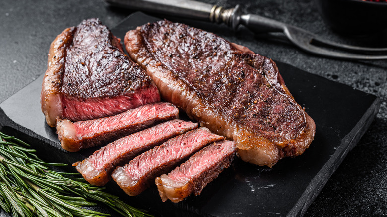 Sliced top sirloin steak on a board