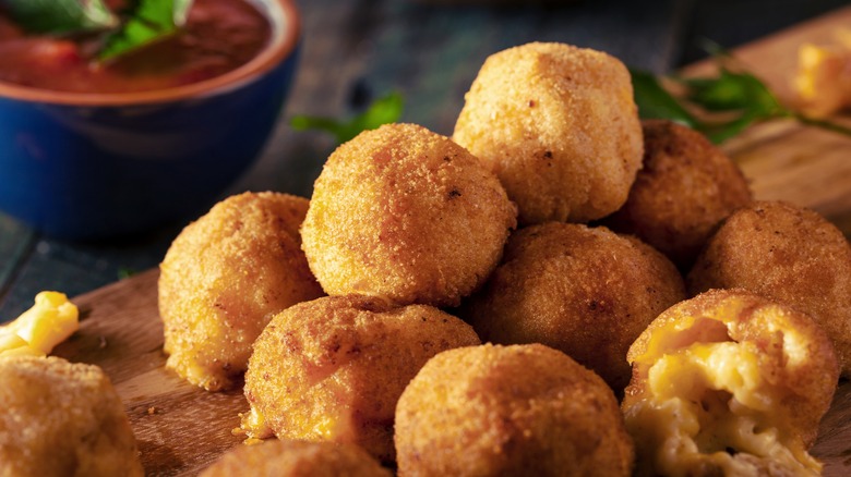 Mac and cheese bites on a cutting board