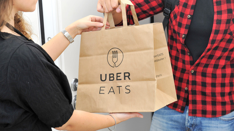 handing uber eats bag