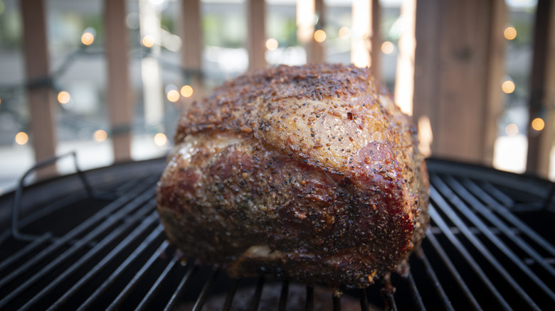 Pork butt sitting on a grill