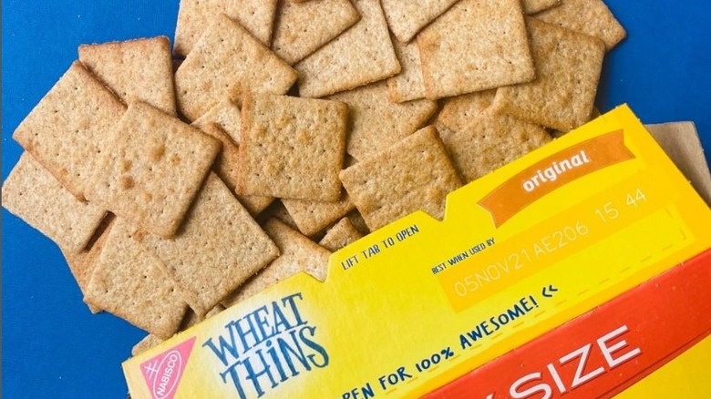 Box of Wheat Thins with crackers spilling out