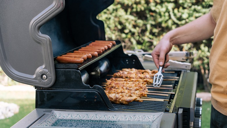 person grilling outside