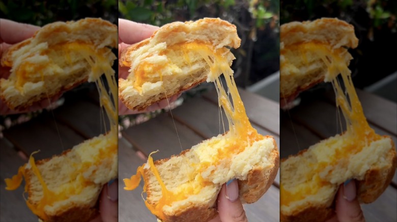 woman pulling apart Whole Foods breakfast sandwich