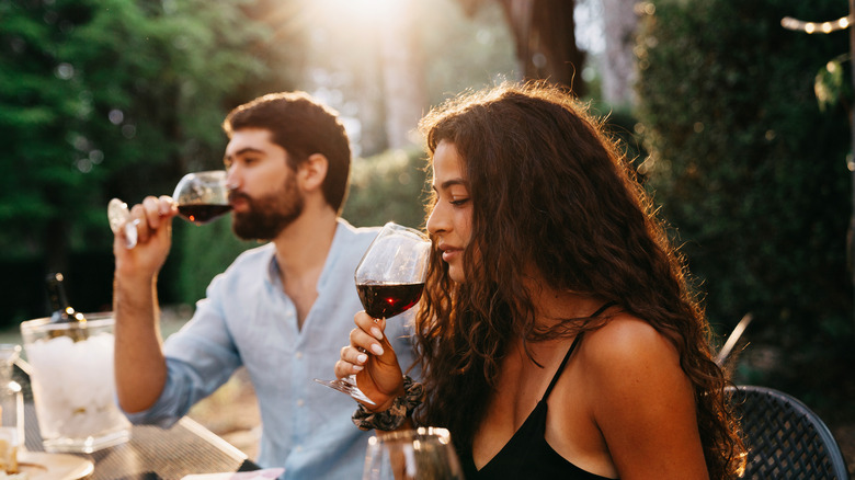 people tasting red wine