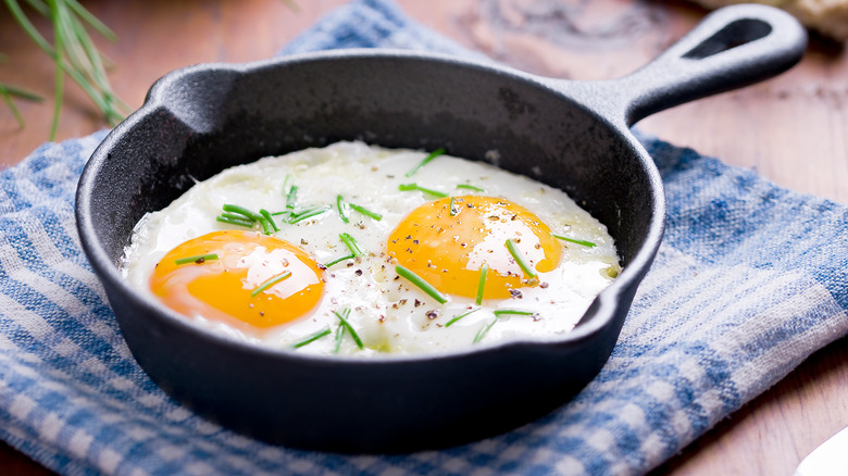 Chives garnishing fresh cooked eggs