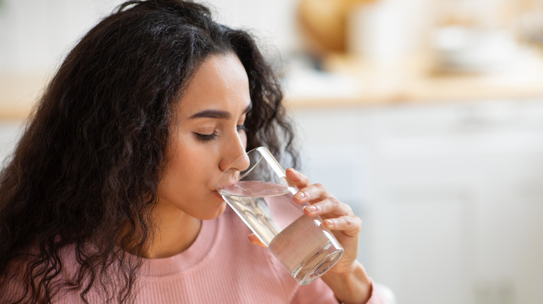 a woman drinks water