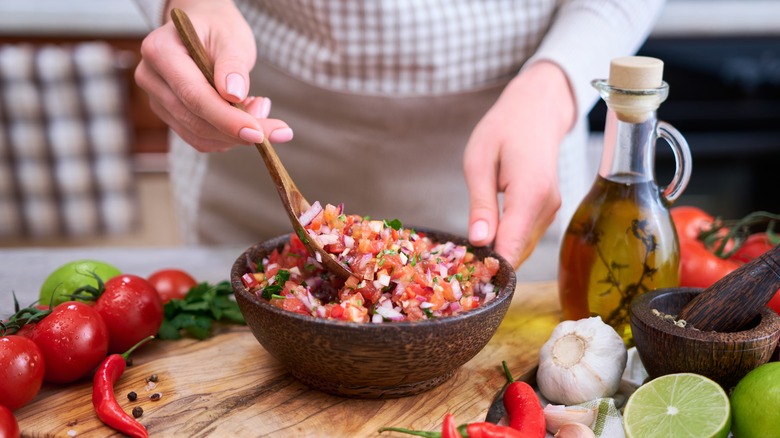 woman mixing salsa