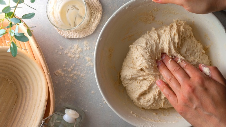 man making bread in kitchen