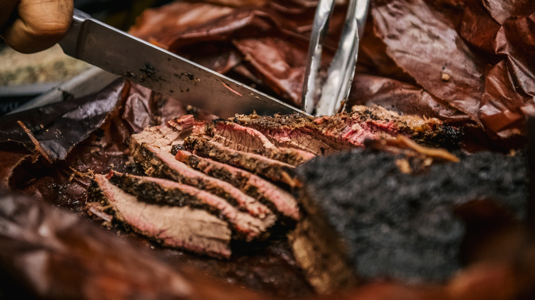 Slicing beef brisket with knife