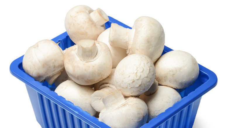 open package of white mushrooms 