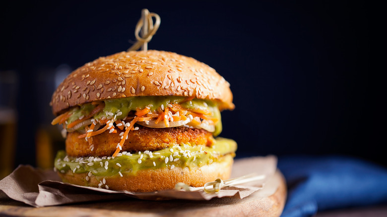 Potato veggie burger on paper and a cutting board