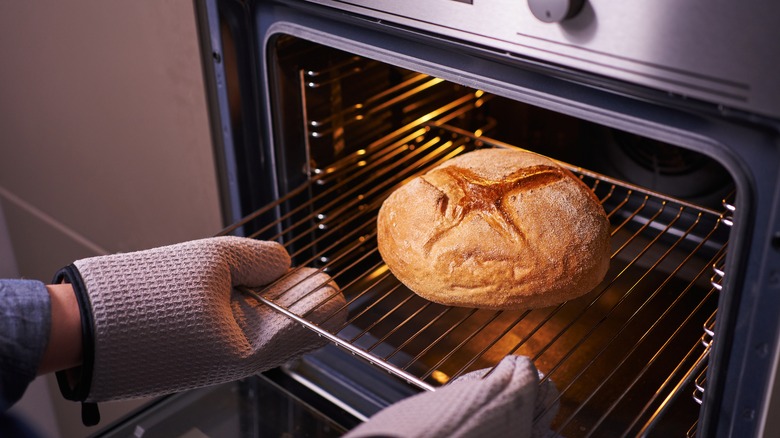 mitts taking bread from oven