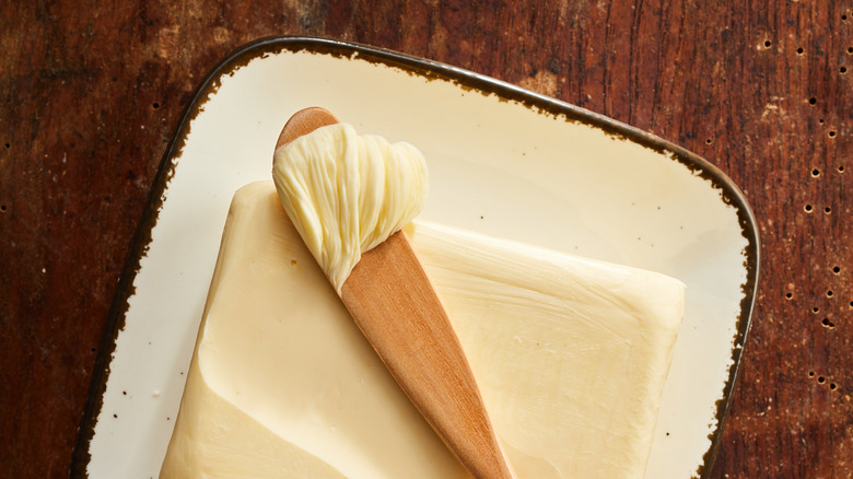 Pat of fresh butter on a wooden table