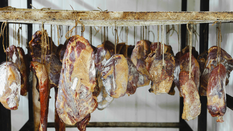 cuts of meat hanging to dry