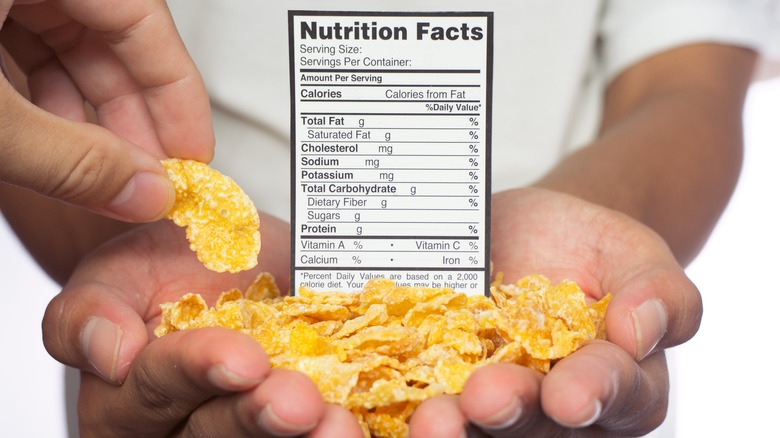 Man holding cereal with nutrition 