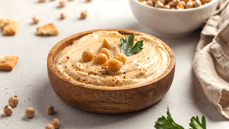 Chickpeas and hummus in wood bowl