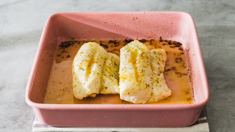 cod filets in baking dish with butter